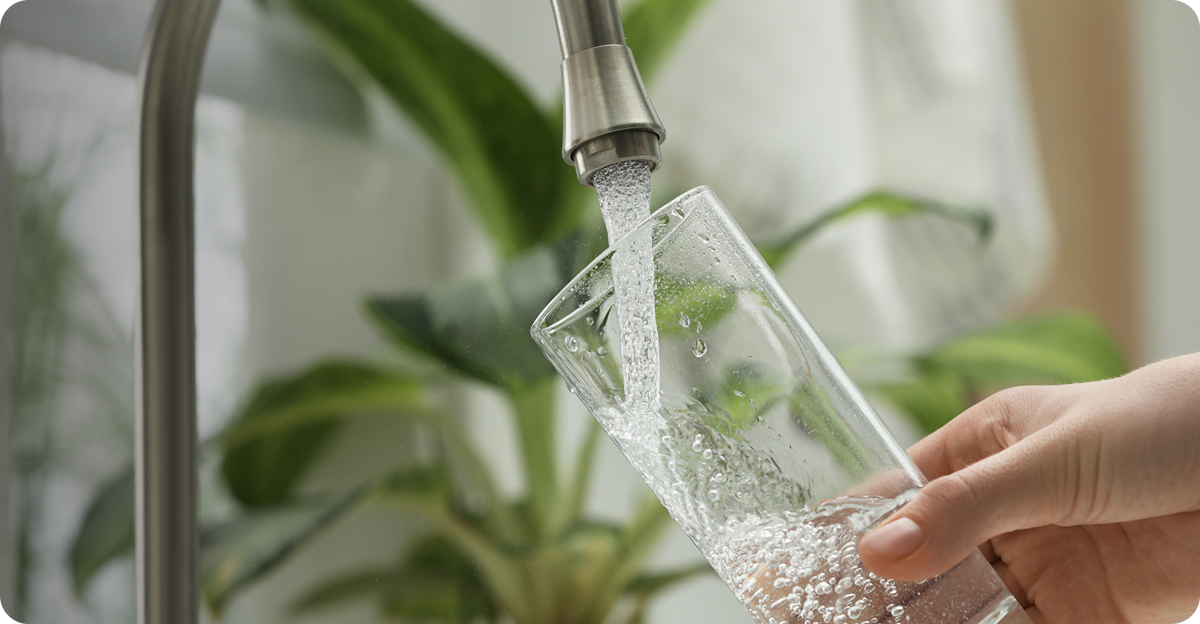 Hand filling glass with clean water