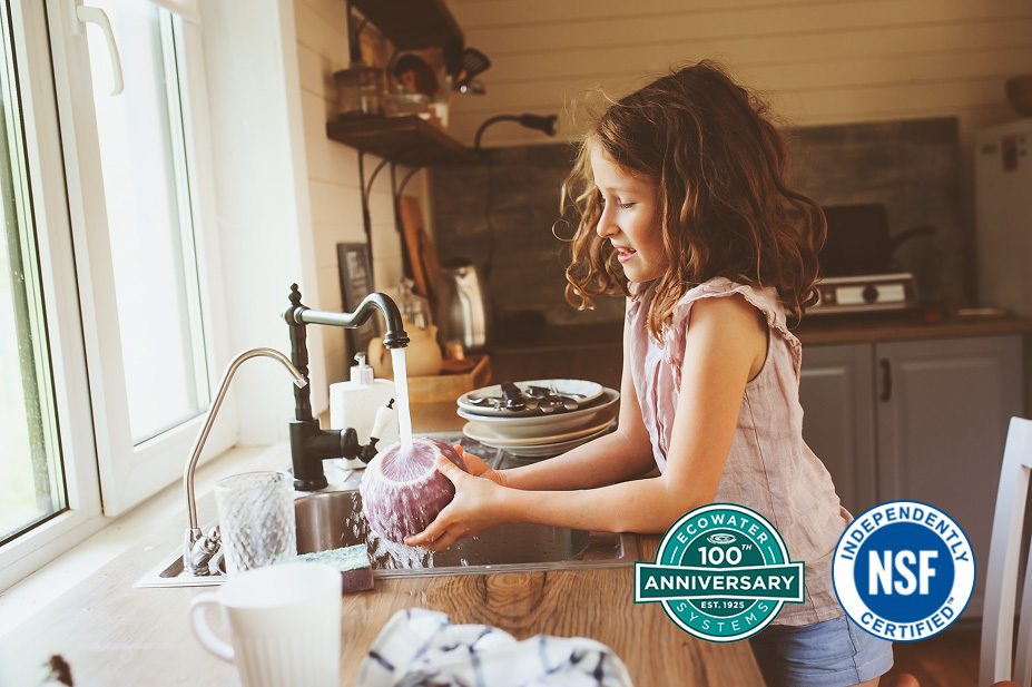 Family in kitchen with EcoWater system