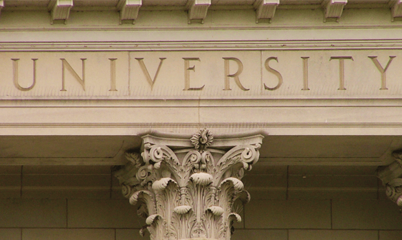 The word “university” engraved into a building above a pillar