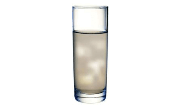 An image of a cloudy glass of water that is contaminated with sediment