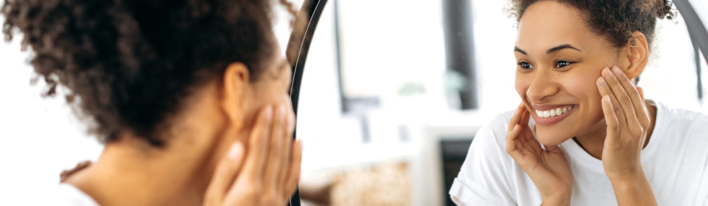 A woman looking at herself in the mirror