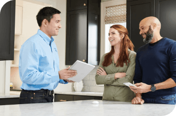 A dealer talking to two customers in their home