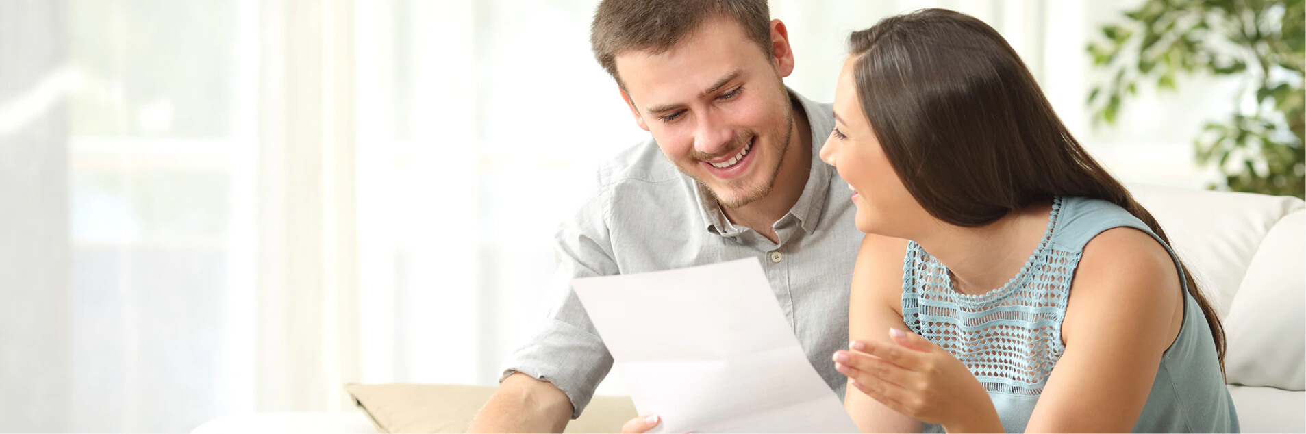 man and woman looking at a piece of paper