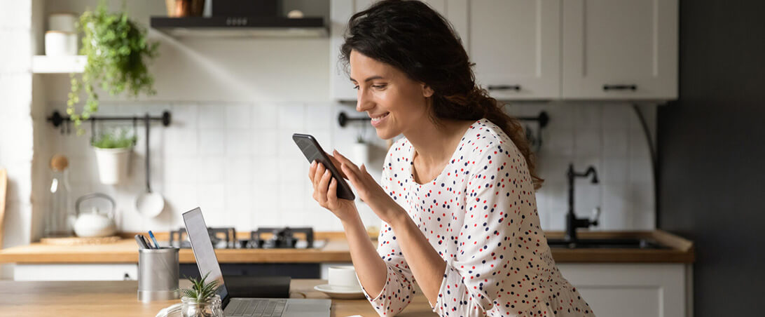 A woman smiling looking at a cellphone