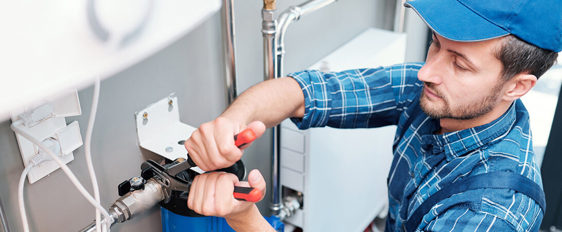 A man working on a machine with pliers