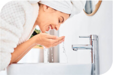 A woman washing her face