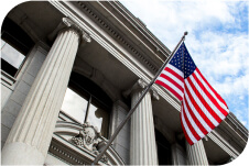 The outside of a government building with an American flag.