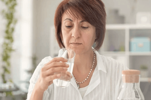 A woman staring at a glass